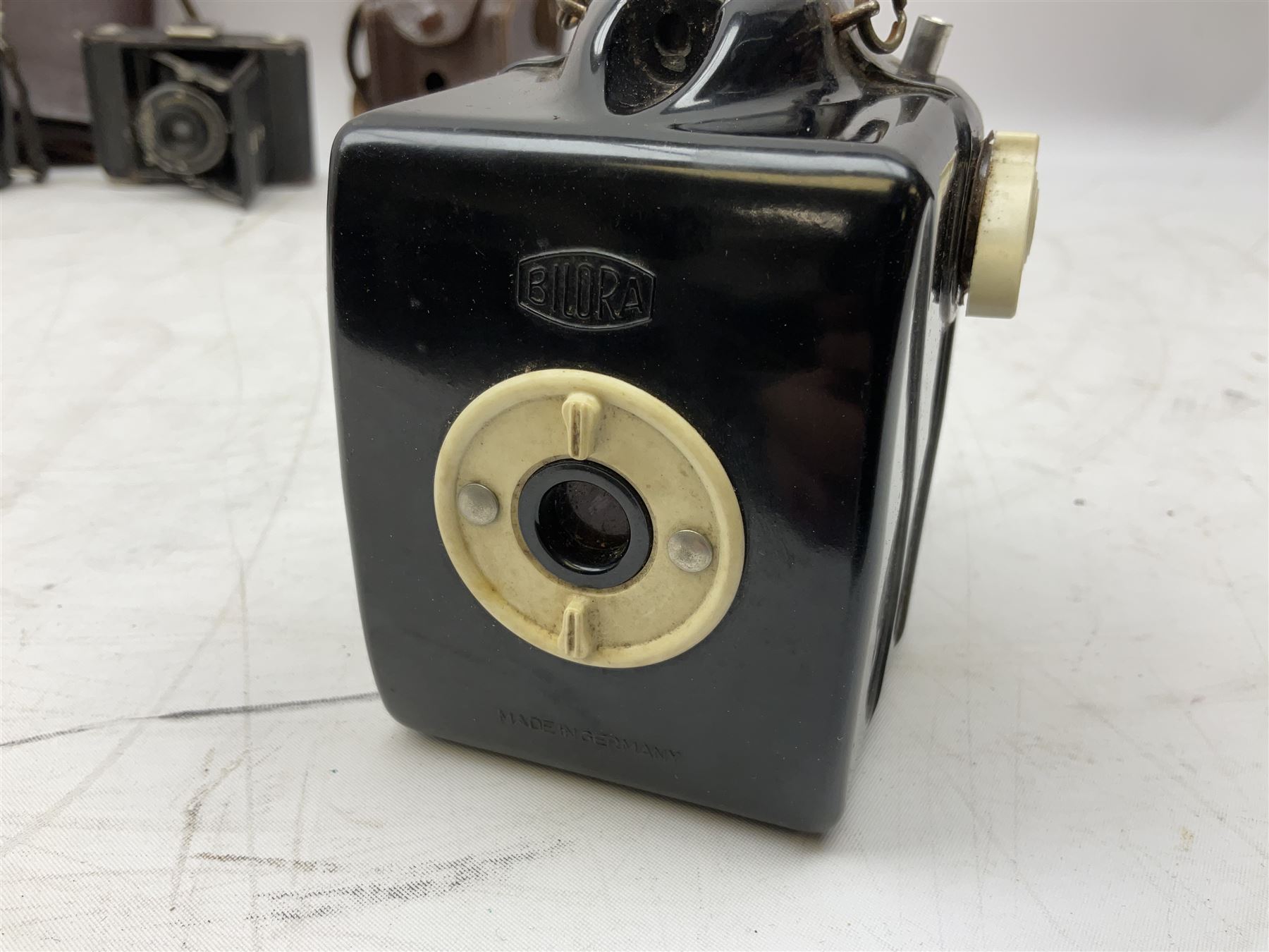 Bilora Boy Box Camera, with leather case, together with Zeiss Ikonta folding camera and another similar example 