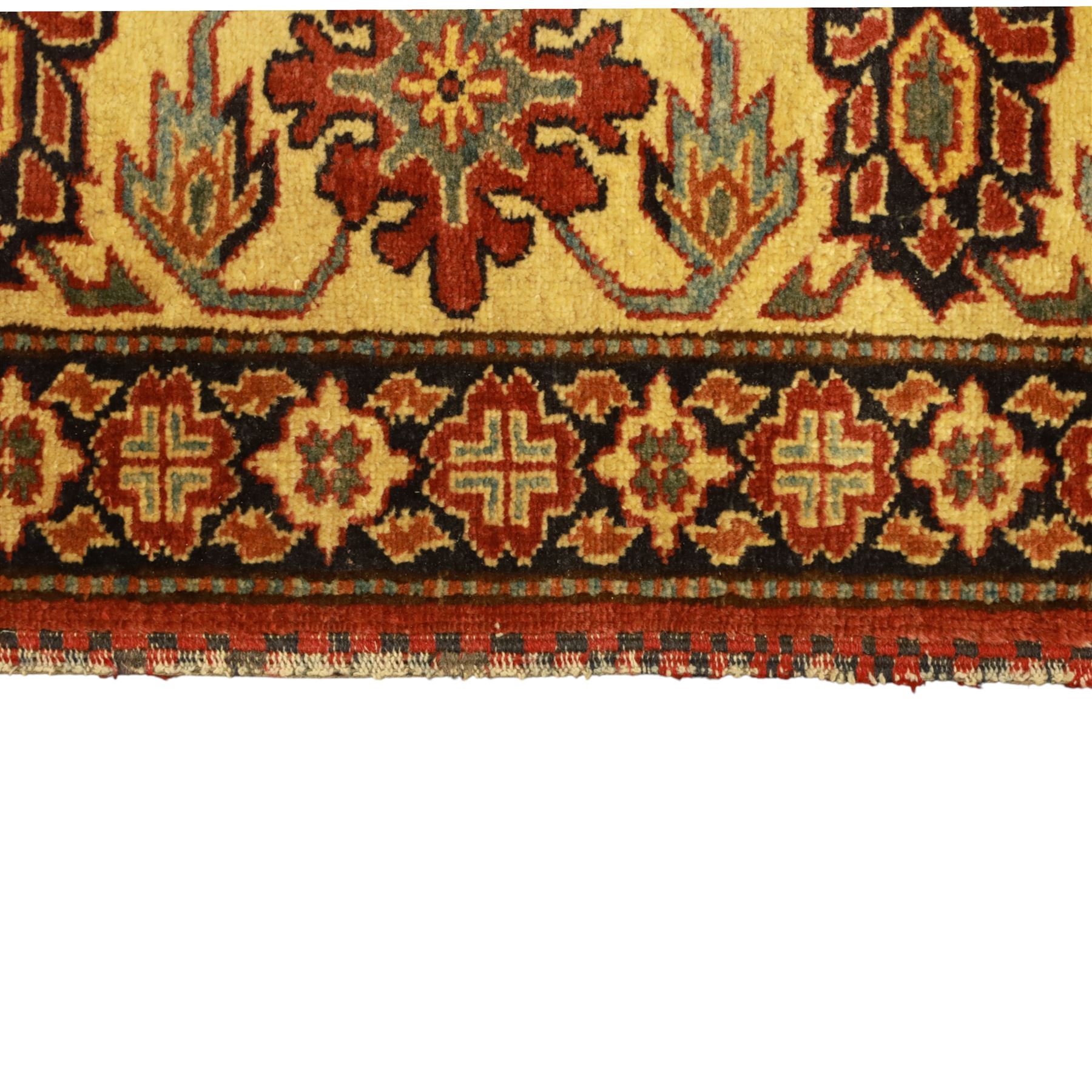 Afghan Gazni Kazak rug, the hand-knotted wool pile featuring a rust red ground with all-over geometric floral motifs in ivory and dark green, enclosed by a wide ivory border with stylised rosettes and angular vine decoration, fringed ends, from the region of Ghazni, Afghanistan