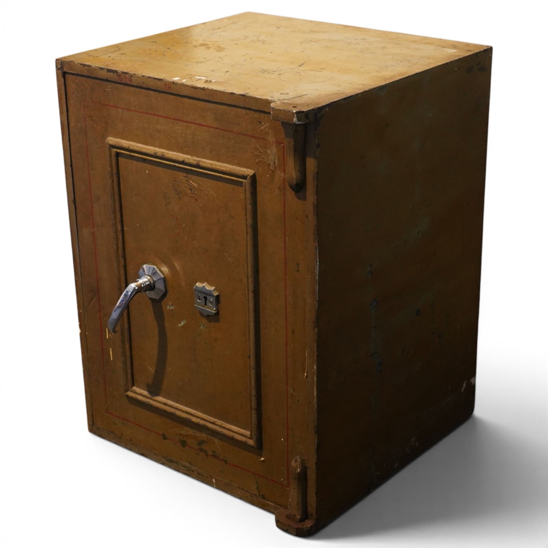 Early 20th century painted iron and steel safe, square form with moulded panel door, applied handle and lock plate with three keys, the interior fitted with twin cash drawers with recessed handles, on low cast feet