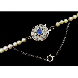 Early 20th century single strand graduating pearl necklace, with white gold milgrain set diamond and sapphire clasp