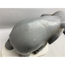 Composite figure of an elephant, painted grey, upon white base, L45cm H65cm