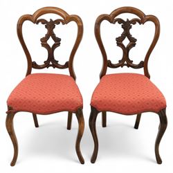Set of four Victorian walnut balloon back chairs, with a carved and pierced back splat with foliate scrolls, serpentine seat upholstered in a diamond pattern fabric, raised on cabriole legs 