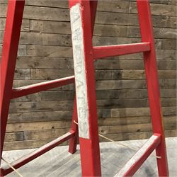 Pair of vintage red painted A frame trestles, with original A W Oates Painter signage