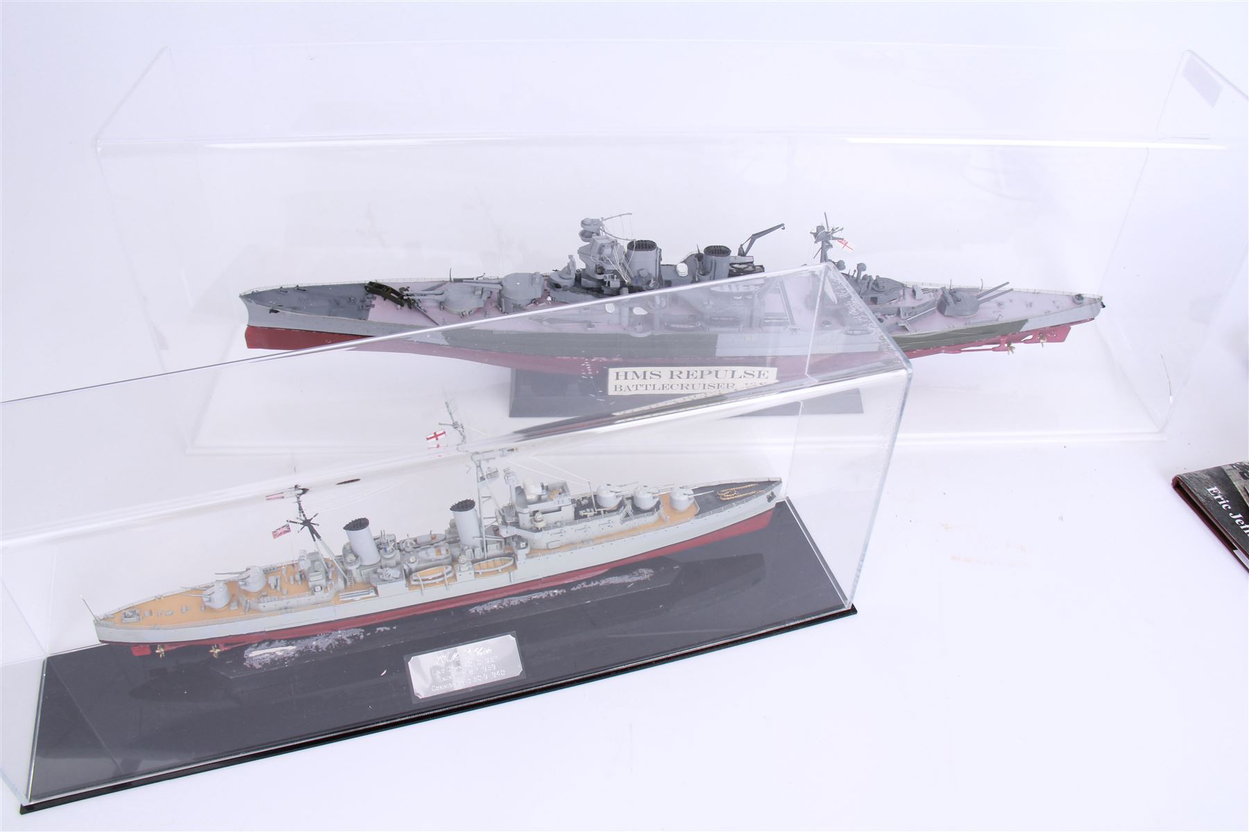 Two ship models in display cases; HMS Repulse, 1941 and HMS Dido, 1939, together with a book about HMS Dido, largest H27cm 
