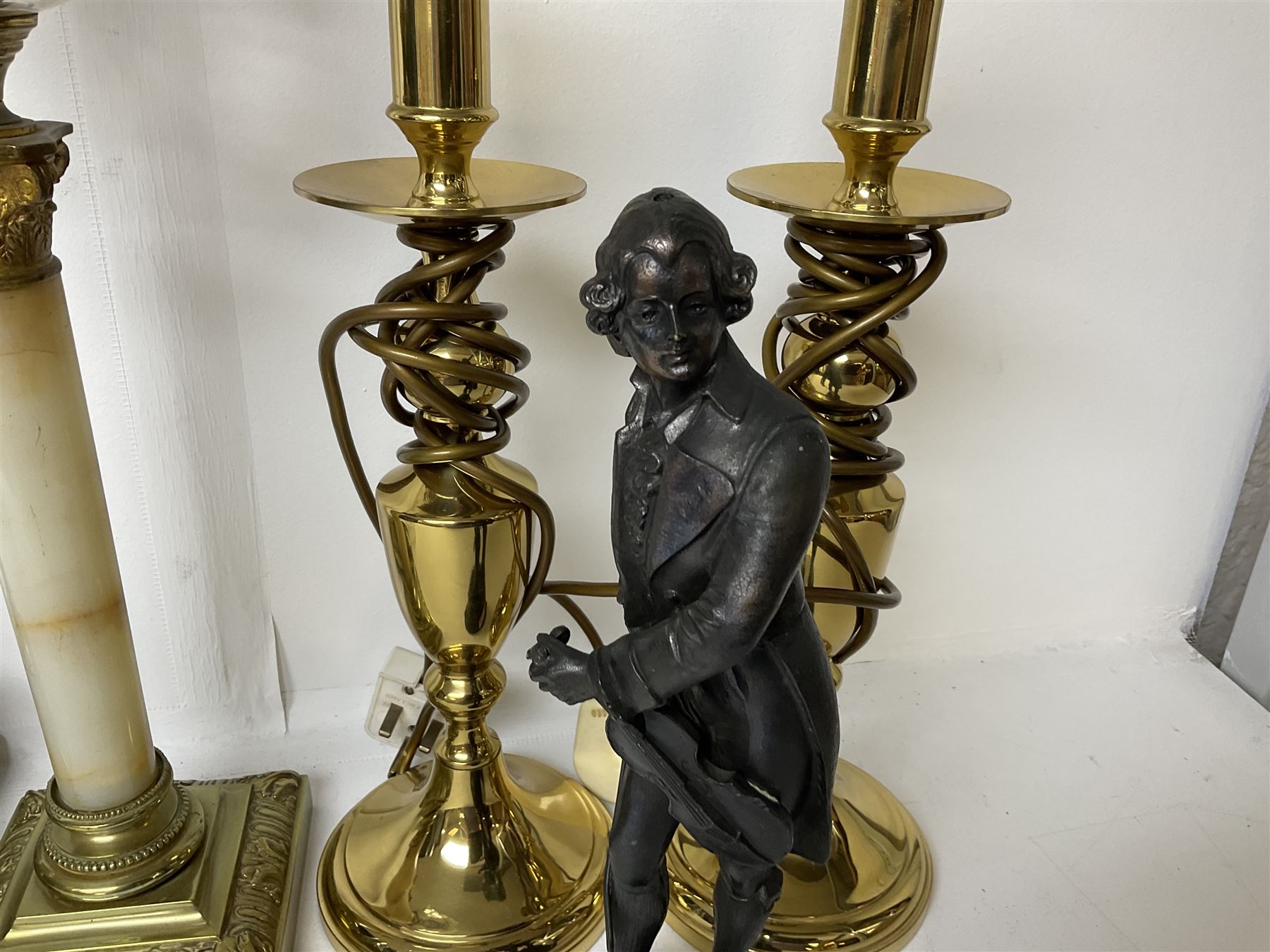 Oil lamp with frosted floral shade and cut glass reservoir, upon cast brass and marble base, together with a cast brass Corinthian column table lamp, pair of brass table lamps and a composite metal figure of a violinist 
