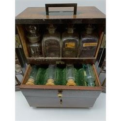 19th century mahogany travelling apothecary cabinet, with recessed brass carry handle to top, and two deep-section hinged doors to the front opening to reveal a fitted interior with clear glass bottles and two drawers, H27cm