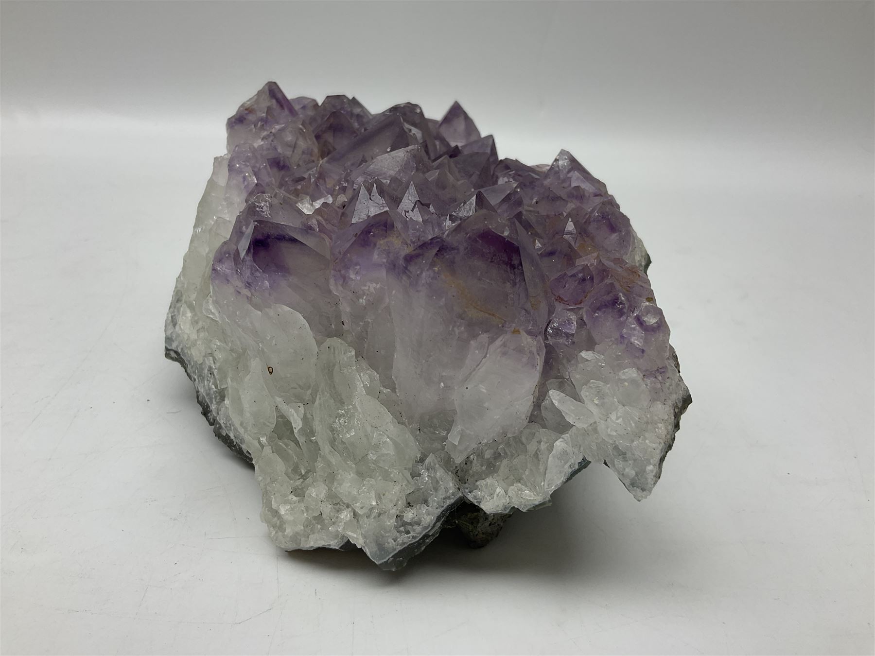 Amethyst crystal geode cluster, with well-defined crystals of various sizes, H10cm, L30cm
