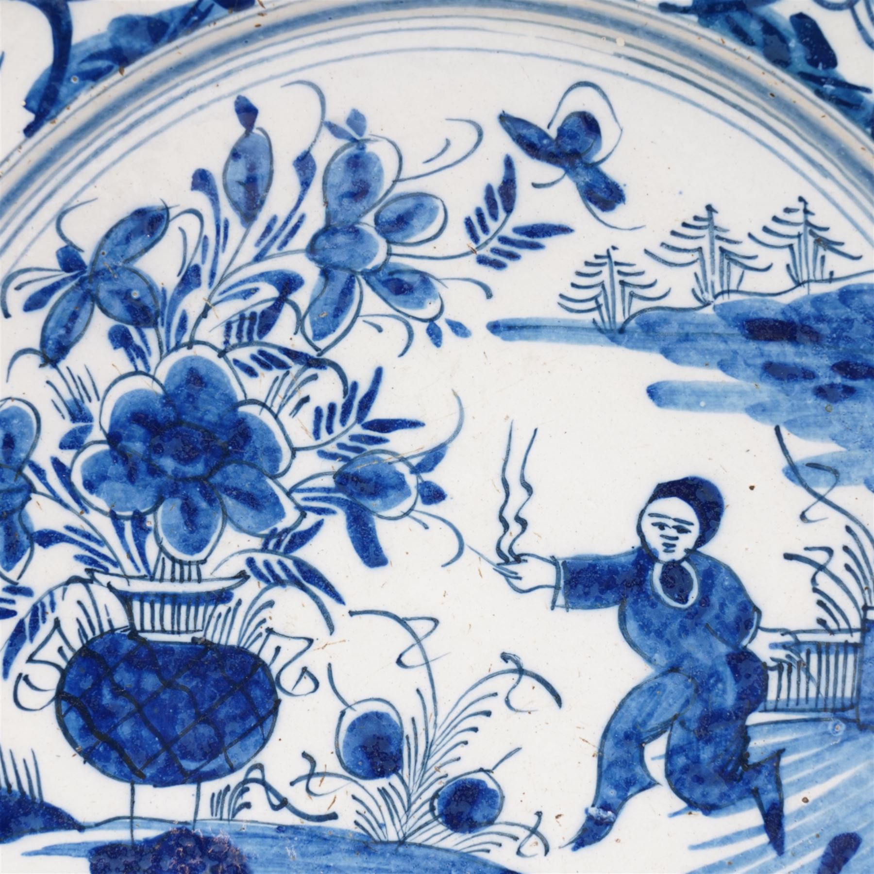 18th century English Delft dish, possibly Lambeth decorated with Chinese figure in a landscape D35cm