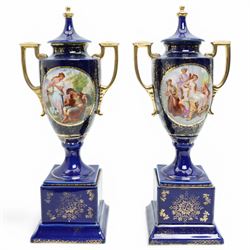 Pair of Vienna style blue porcelain two handled vases and covers painted with classical sc...