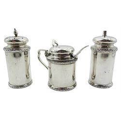 Mid 20th century set of three silver cruets, comprising salt, pepper, and mustard pot and cover with spoon,  each of cylindrical form with flower head borders to rim and base, hallmarked Frank Cobb & Co Ltd, Sheffield 1937, spoon 1936, approximate total weight 6.59 ozt (205 grams)