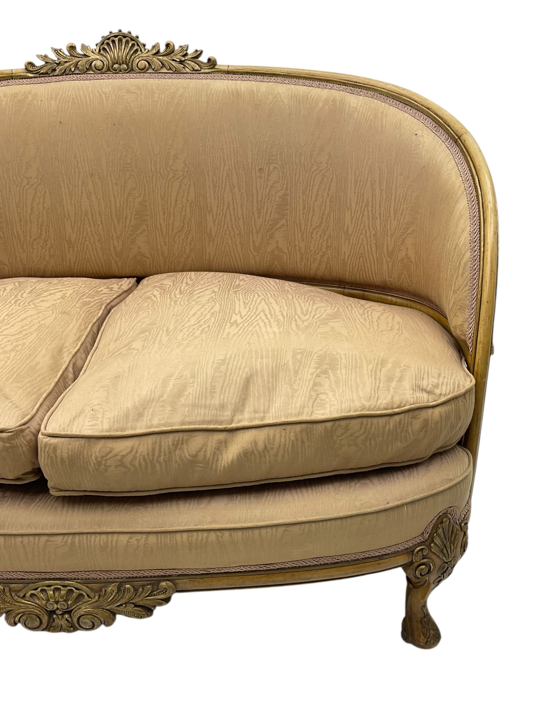 French Louis XV design walnut framed sofa, tub-shaped upholstered back with gilt foliate carved crest, padded seat with twin loose cushions, raised on cabriole supports with shell and acanthus leaf carvings
