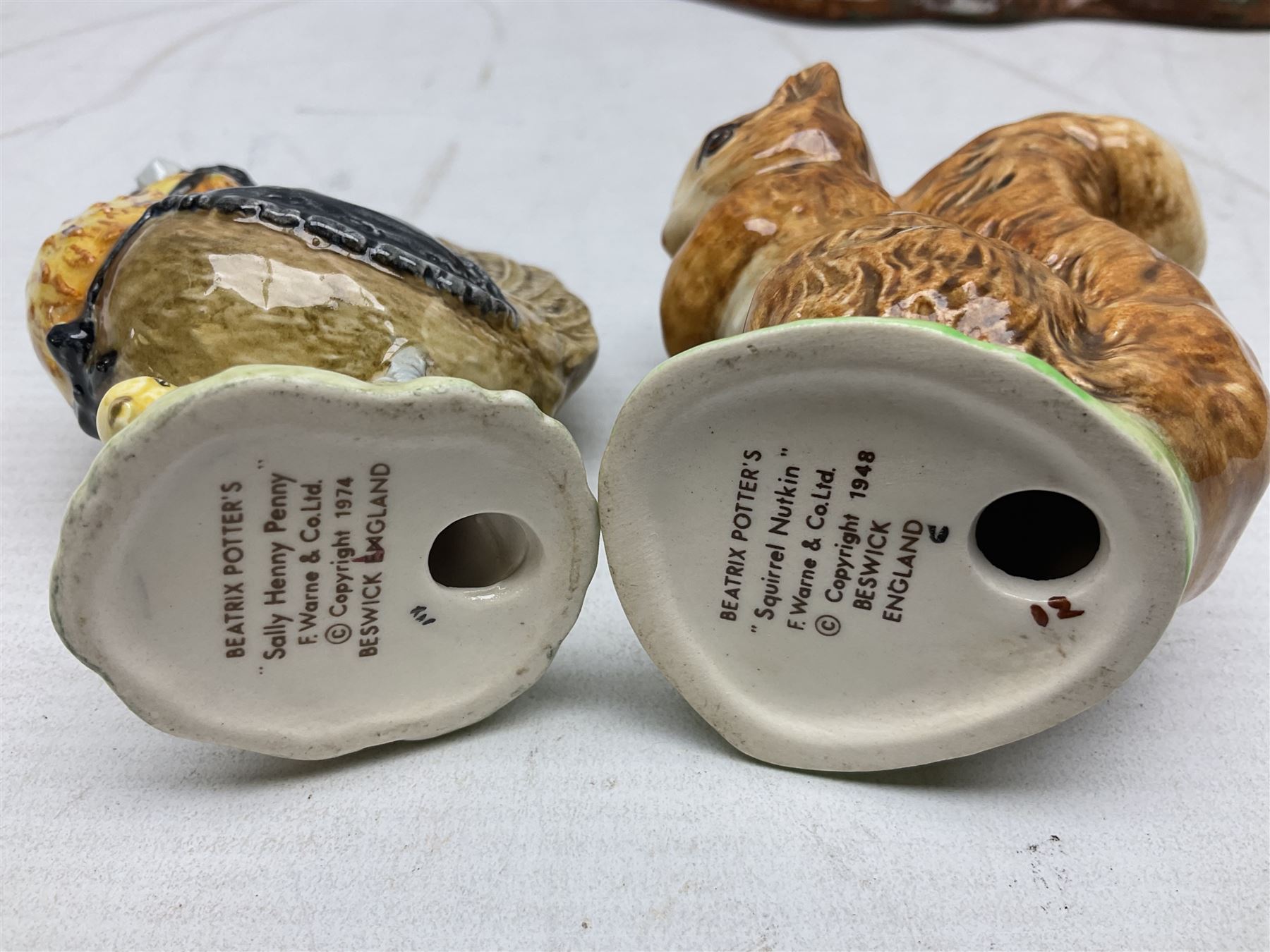 Seven Beswick Beatrix Potter figures, comprising Sally Henny Penny, Johnny Town-Mouse, Mrs Tiggy-Winkle, Mrs Tittlemouse, Tom Kitten, Pig-Wig and Squirrel Nutkin, together with a Beswick tree trunk display stand, stand L30cm