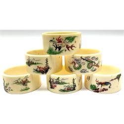 Set of six early 20th century Chinese ivory napkin rings decorated with figural scenes and calligraphy