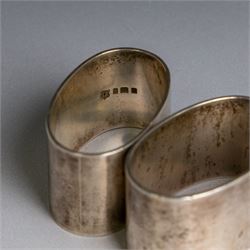 Two silver napkin rings, of oval form with engraved initials, both hallmarked