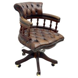Mahogany framed swivel Captains desk chair, upholstered in brown buttoned leather, turned supports and swivel base on castors