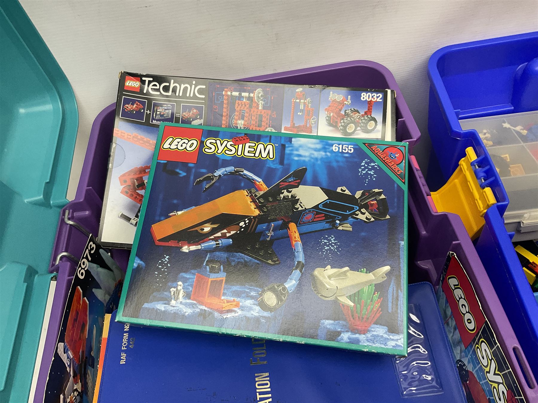 Lego - large quantity of part-built models and loose component parts including Lego Technic and Lego System, space and road vehicles, ships and boats, helicopter etc; together with two set boxes and folder  containing large quantity of instruction booklets; stored in two very large plastic boxes