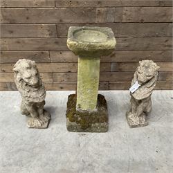 Pair of cast stone seated garden lions, a stone bird bath and various pots and planters