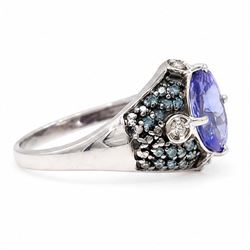 9ct white gold tanzanite and diamond ring, single oval cut tanzanite of approx 1.70 carat, surrounded by four single cut white diamonds and pave set blue diamonds, hallmarked