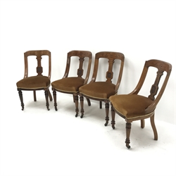 Set of four Late Victorian walnut dining chairs, carved decoration to the top rail and stiles, turned legs with a fluted detail and upholstered seats, W52cm 