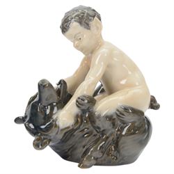 Two Royal Copenhagen figures comprising Faun with Snake no. 1712 and Faun with Bear no. 648