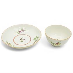 Worcester tea bowl and saucer, c.1770, painted with polychromatic floral sprays within blue borders, bearing crescent marks to base, with another similar early example, unmarked