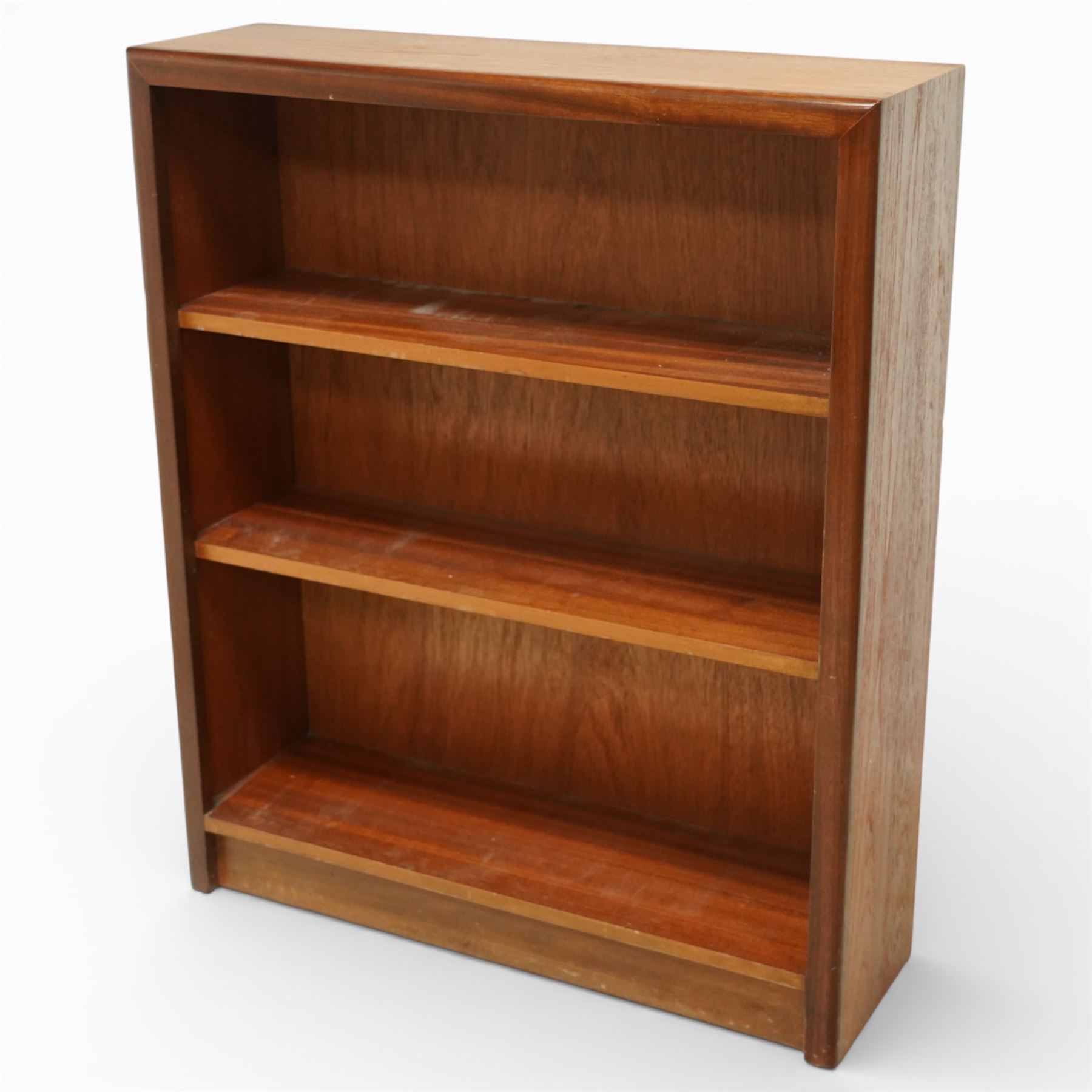 Mid 20th century teak bookcase, of rectangular form with plain top above three open shelves and a shaped plinth base