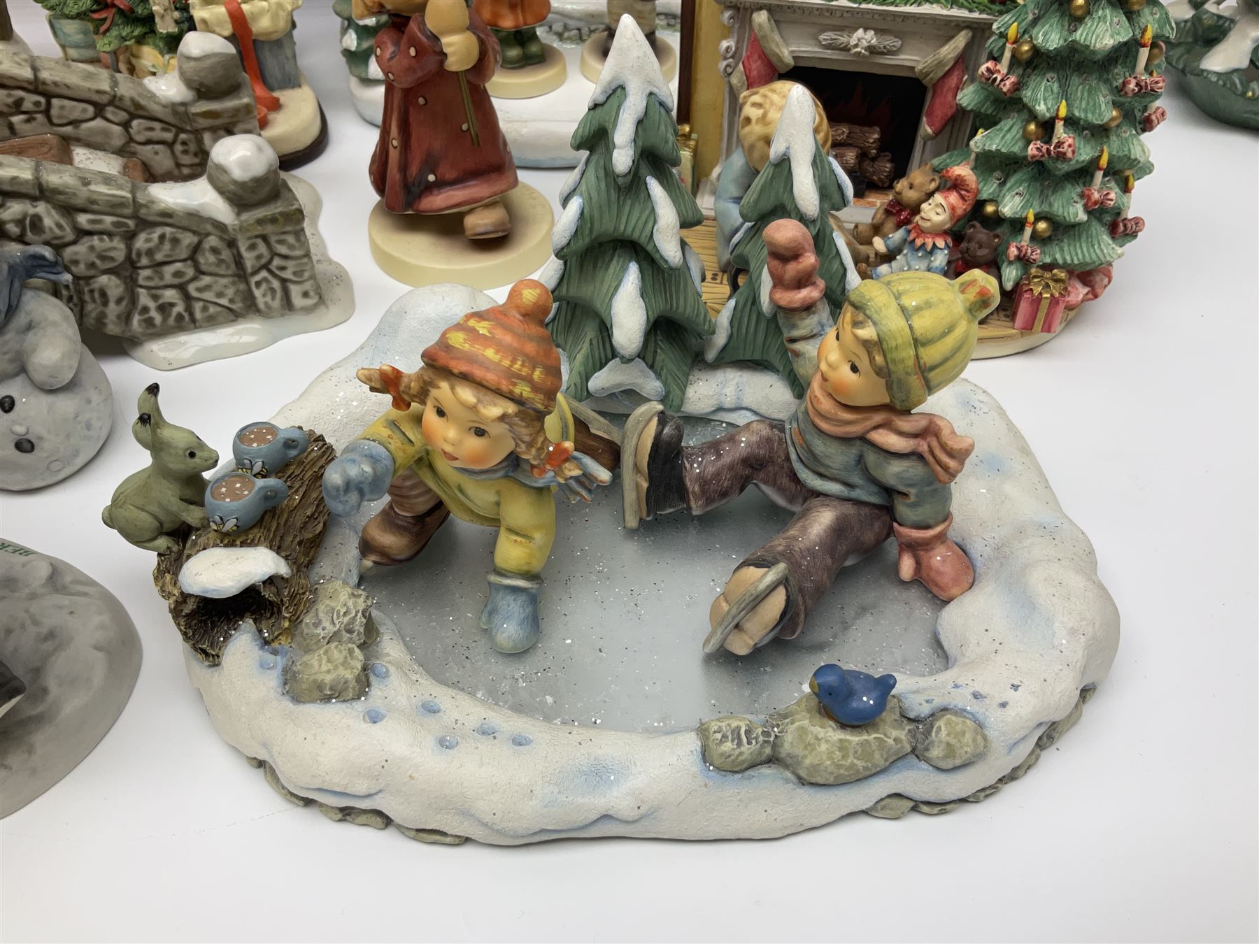 Large collection of Christmas themed Hummel figures and Hummel scapes by Goebel, to include Winter Friend, Making New Friends, Tree Trimming Time, Winter Adventure etc