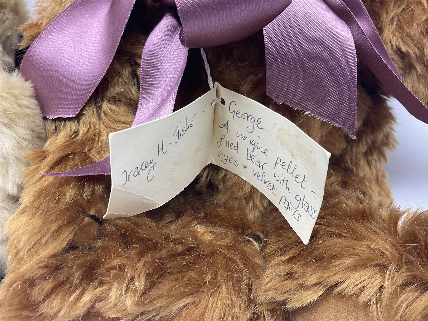 Group of five teddy bears comprising ‘George’ a unique pellet filled bear with glass eyes and velvet paws H38cm, and ‘Abbey’ a luxury German plush with wobble head and glass eyes no.5/10 H24cm, both with Teddies from Bearyland labels; along with two light blonde mohair H. M. Bears and Boyds Bears ‘T. F. Wuzzies’ no. 595140 (5)