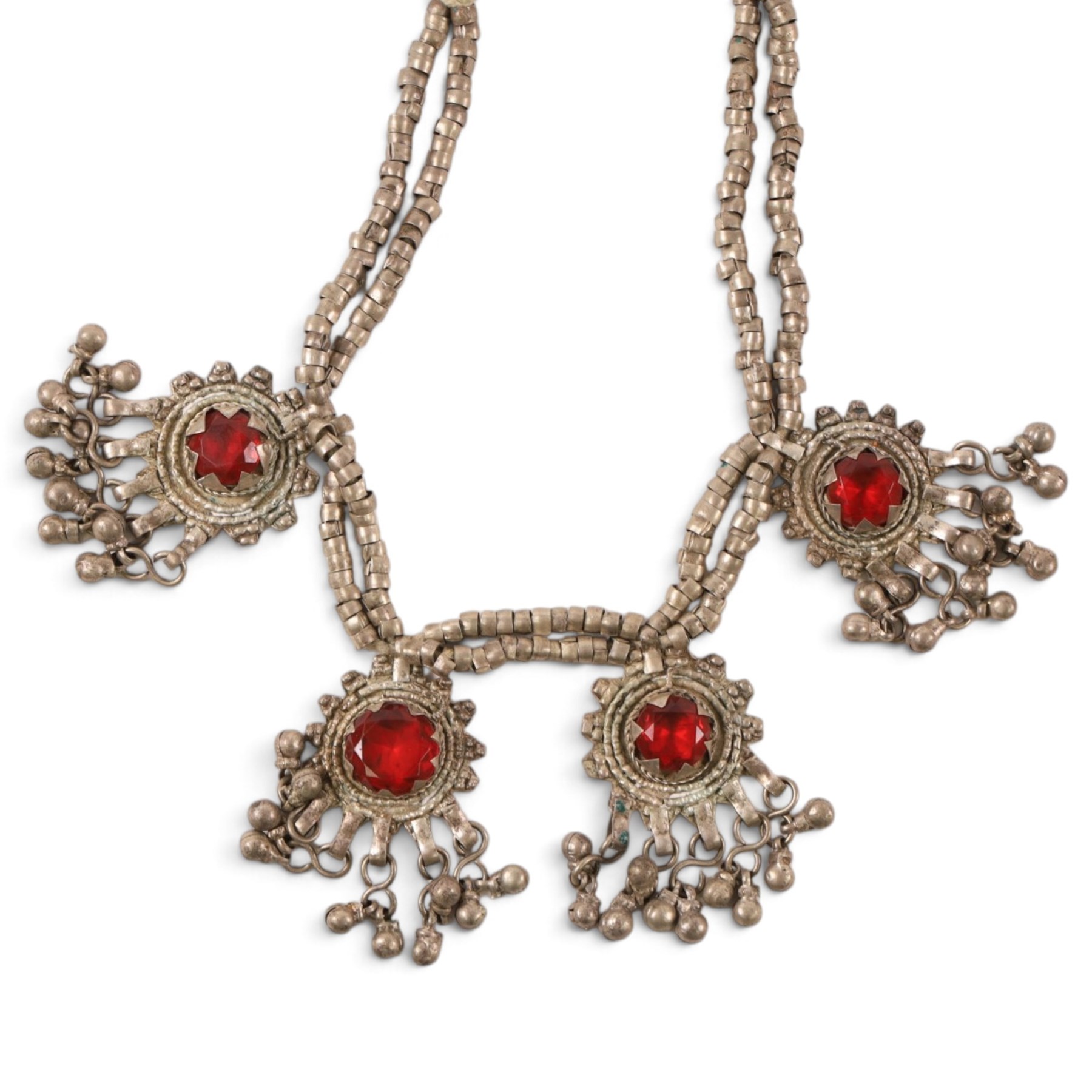 Collection of Middle Eastern jewellery, including silvered multi strand necklace with beadwork and filigree decoration with three cylindrical pendants, pendant necklace with central orange cabochon, beadwork choker and similar  