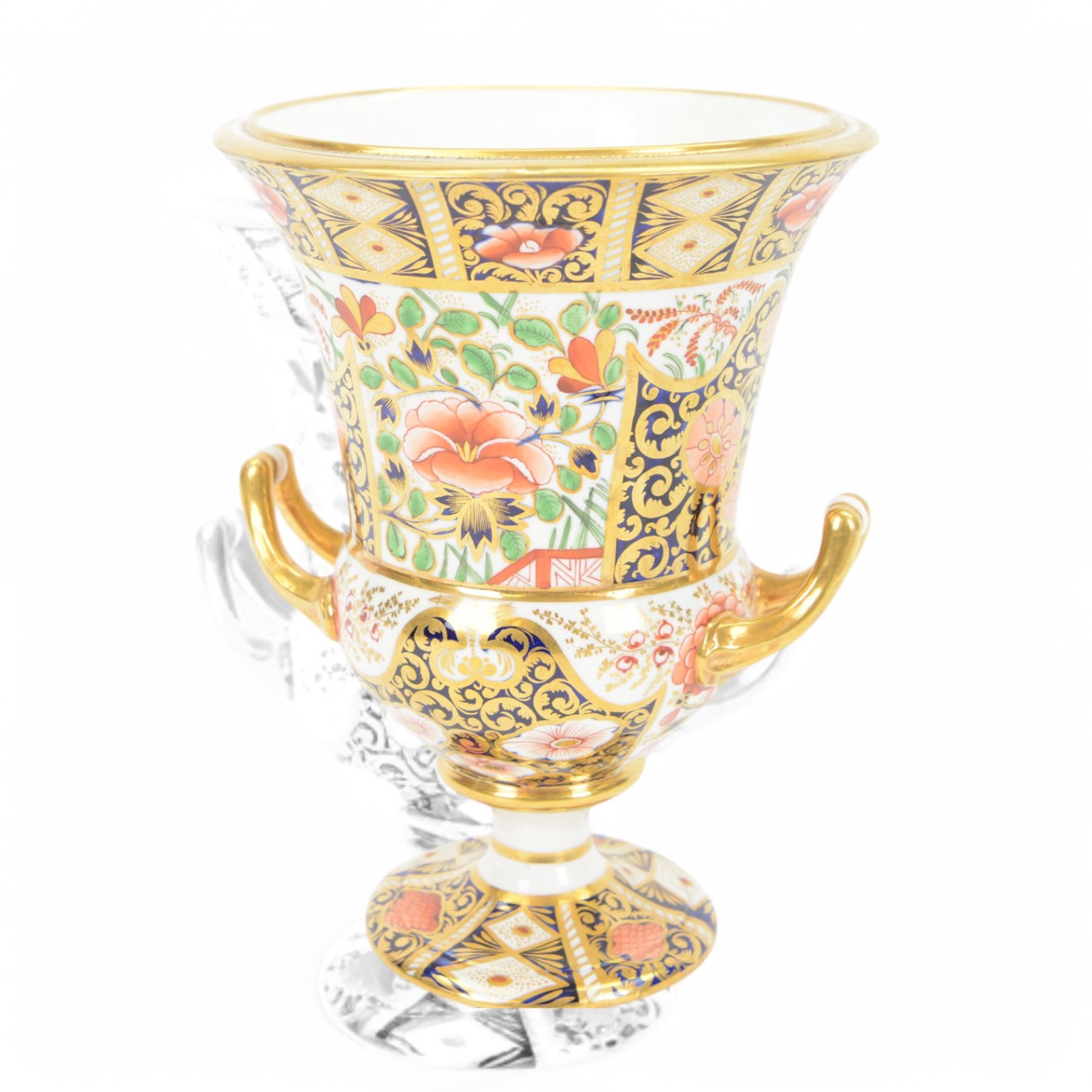 Royal Crown Derby campana vase, decorated in imari pattern, with gilt handled upon a circular base, with mark beneath, H22cm