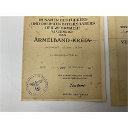 Three German documents dated 1942 - Gold Cross award to Major Ludwig Osterkampf; and Crete wound certificate and cuff title certificate awarded to Feldwebel Alfred Glaise; all unframed (3)