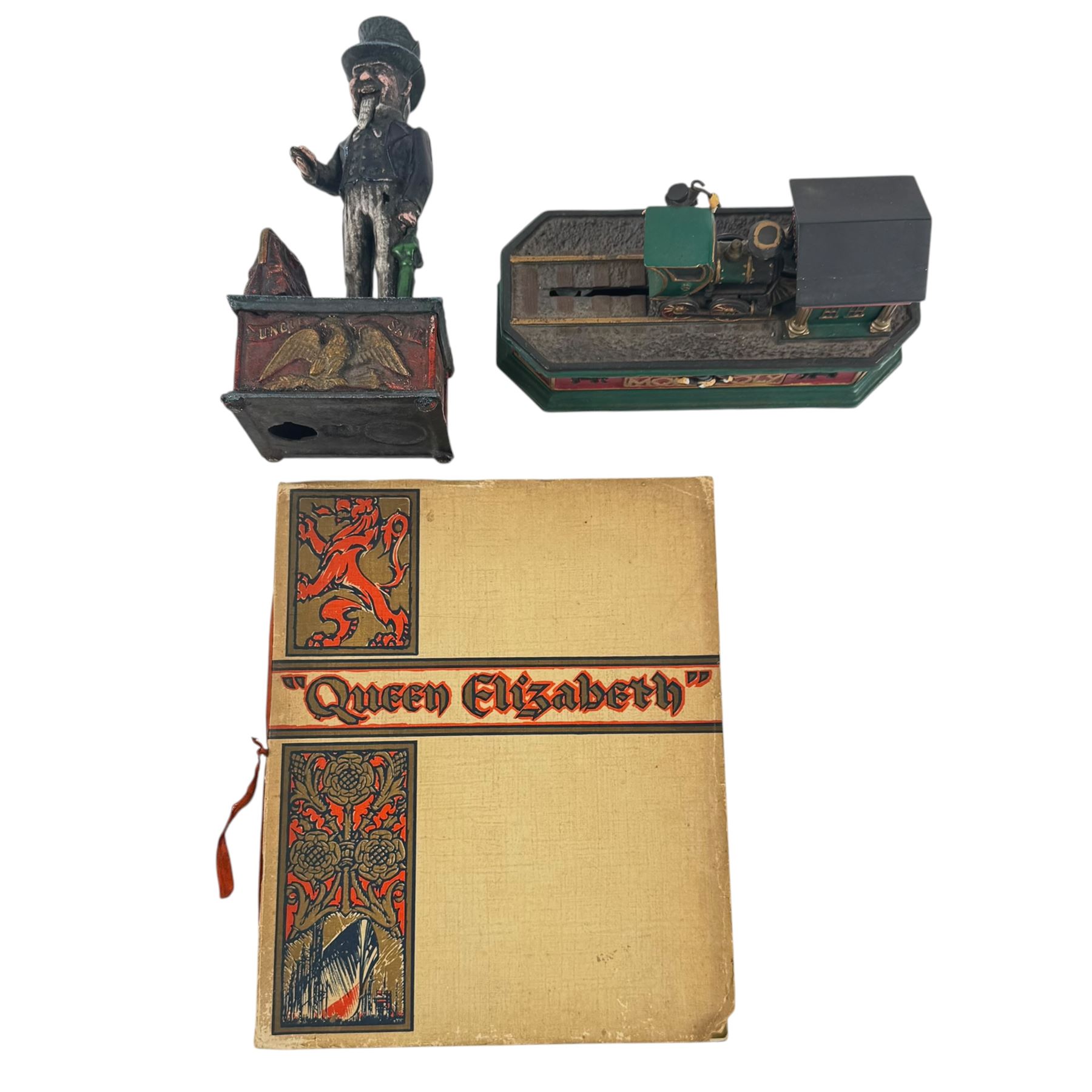  Uncle Sam mechanical money, together with The Monopoly collectors bank and Queen Elizabeth book  
