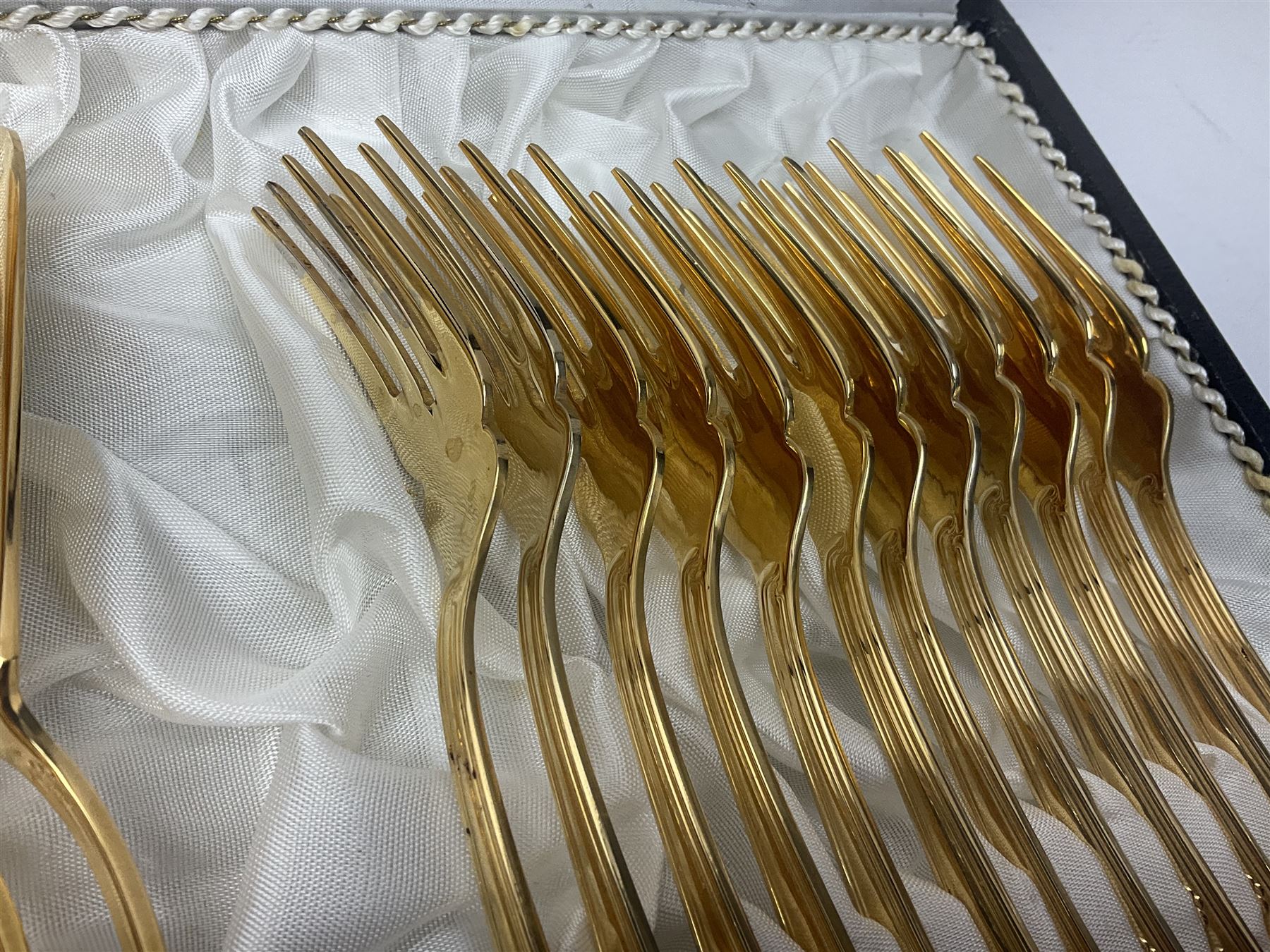 Bestecke Solingen canteen of gold plated cutlery for twelve place settings, including ladle, cake slice and serving spoons, contained within a briefcase, together with a matching set twelve of Bestecke Solingen gold plated fish knives and forks, in fitted case 