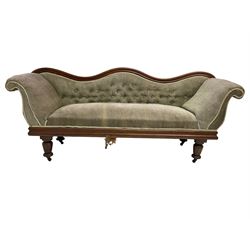Victorian walnut settee, serpentine and moulded cresting rail, buttoned upholstery, scrolled arms and moulded frieze rail, on turned feet with castors