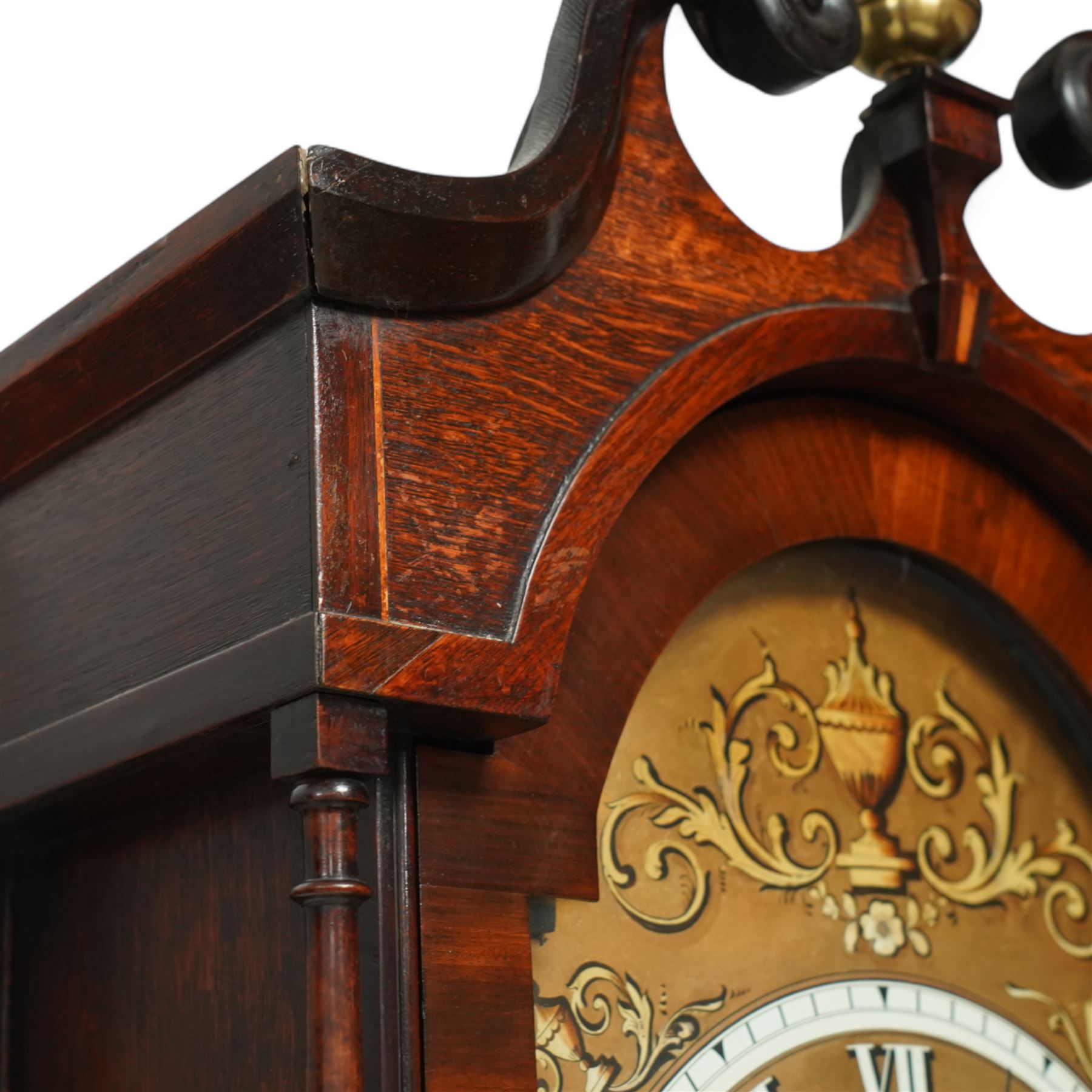 John Henry Coates of Wakefield- late19th century oak and mahogany 8-day longcase clock c 1860, with a swan necked pediment and central brass ball and spire finial, break arch hood door flanked by unusual turned pilasters, trunk with recessed rectangular corners and a wavy topped door, on a square plinth with conforming recessed corners and raised on a shaped base, fully painted dial with matching decorative rococo painted decoration to the spandrels and arch, with 