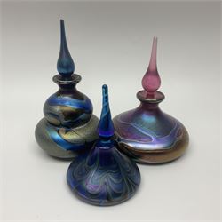 Three Okra scent bottles, the first example of gourd form, decorated with iridescent threads in blues, greens and browns, another of squat form with iridescent designs in purples, pinks and golds and one other, largest H14cm