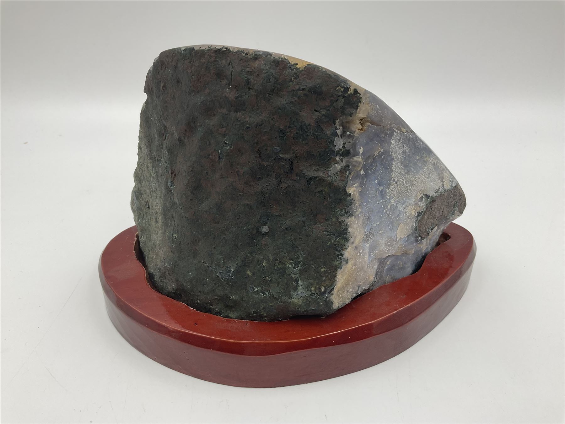 Amethyst crystal geode cluster, with well-defined crystals of various sizes, upon a carved wooden stand, H12cm, L20cm