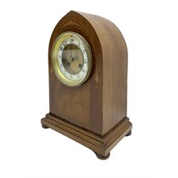 French - mahogany 8-day lancet clock c1910, with an inlaid front raised on a shallow plinth with bun feet, two part dial with a recessed gilt centre and enamel chapter, Arabic numerals, minute markers and steel hands, twin train striking movement sounding the hours and half-hours on a coiled gong, with pendulum and key