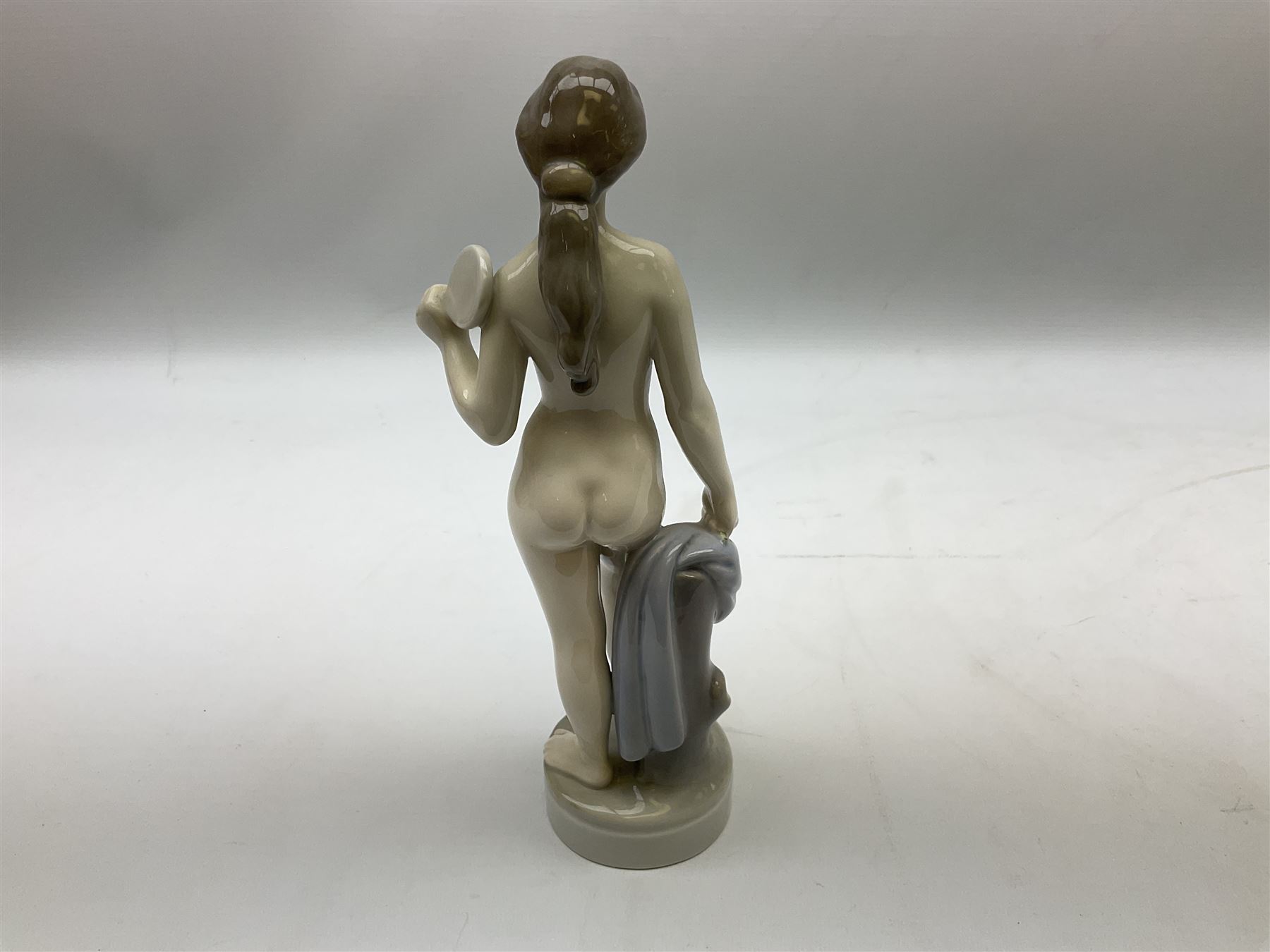 Royal Copenhagen 'Helena' figure modelled as a nude girl holding hand mirror, designed by Hans Hansen, model no. 4639, with printed and painted marks beneath, H25.5cm