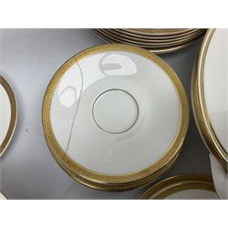 Royal Doulton Royal Gold pattern tea and dinner service for eight, comprising dinner plates, side plates, tea plates, soup bowls, sauce boat and saucer, dessert bowls, coffee cans and saucers, teacups and saucers and two lidded tureens