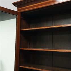 Large Edwardian walnut and satinwood enclosed bookcase-on-cupboard, projecting cornice over two glazed doors with satinwood and ebony banding and stringing enclosing three adjustable shelves, over two panelled doors enclosing two drawers above shelf, on skirted base