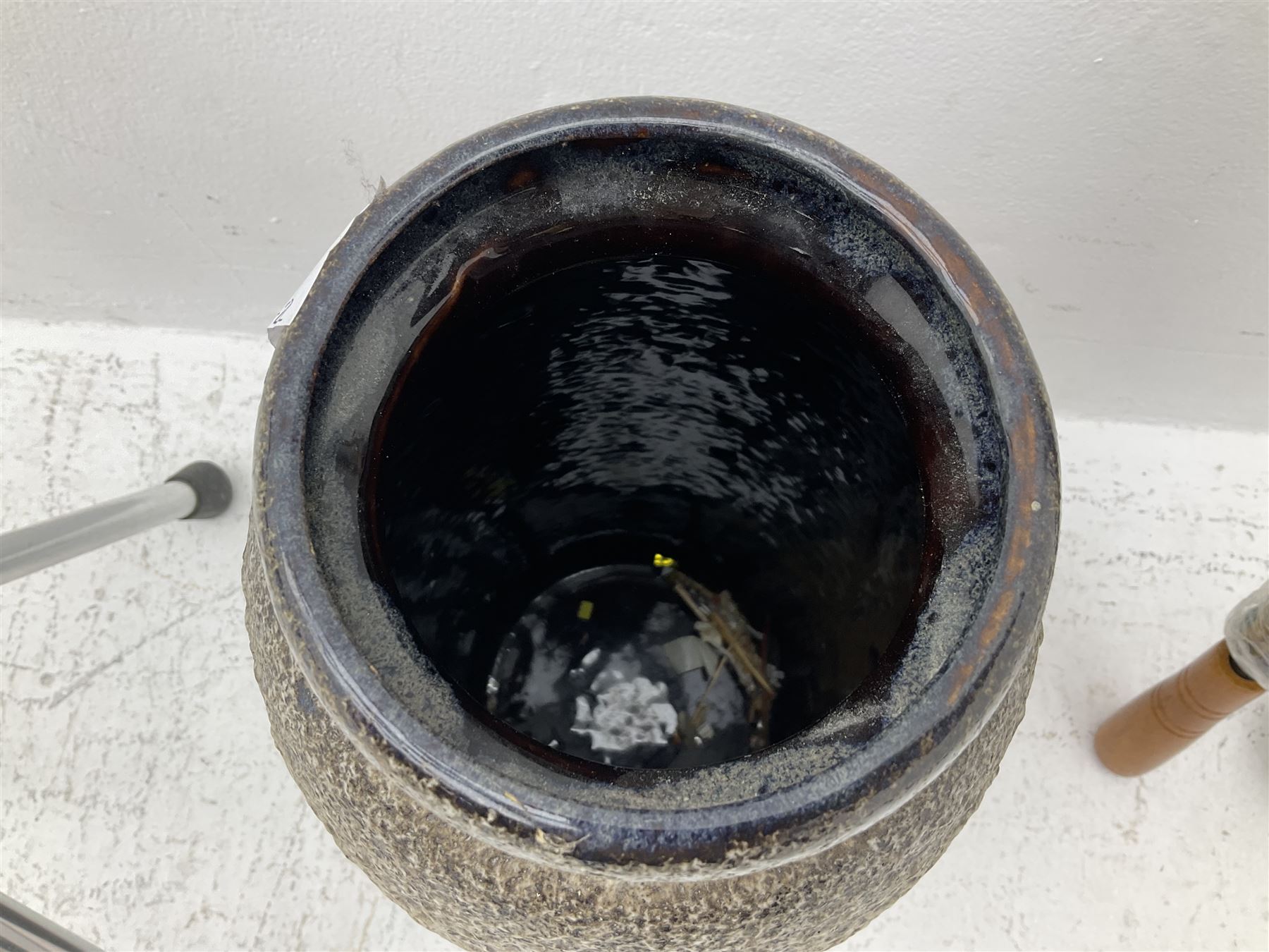Two smooth polished ram horn handled Shepherd's crooks and a further similar example, together with various shooting sticks, walking sticks and canes, housed in a volcanic lava glaze West German style vase