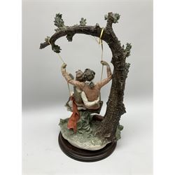 Capodimonte figural lovers on a swing, on raised circular wooden plinth, H43cm