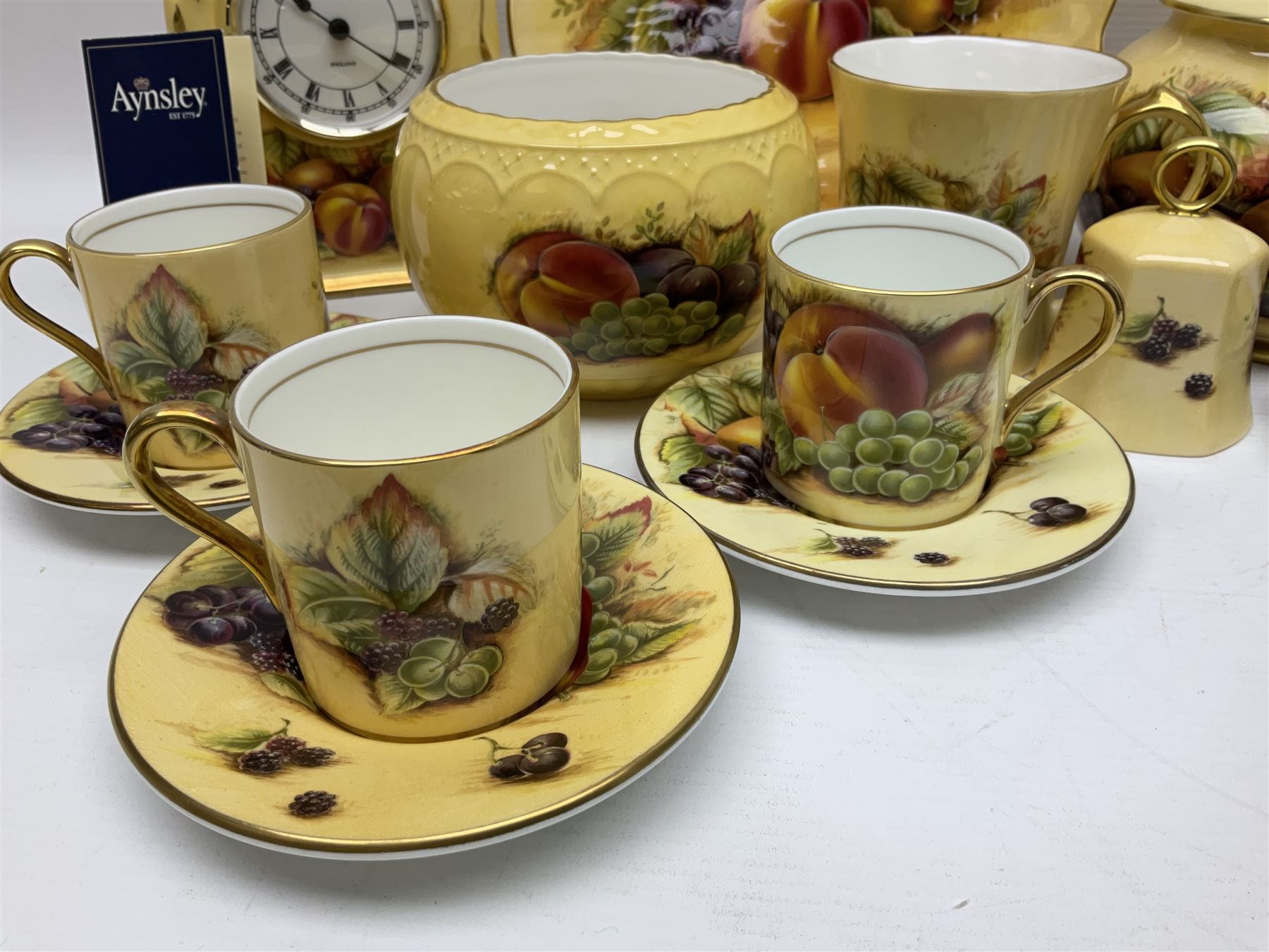 Aynsley Orchard Gold five coffee cans and saucers, mantel clock, plate etc 