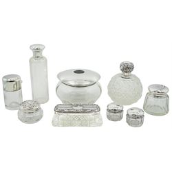 Group of silver mounted cut glass dressing table jars and bottles, of various size and form, to include example of plain cylindrical form with star cut base and hinged cover, opening to reveal stopper, hallmarked John Grinsell & Sons, Birmingham 1890, other examples with various hallmarks, dates ranging 1905 to 2000, approximate total weighable silver 3.31 ozt (103 grams)