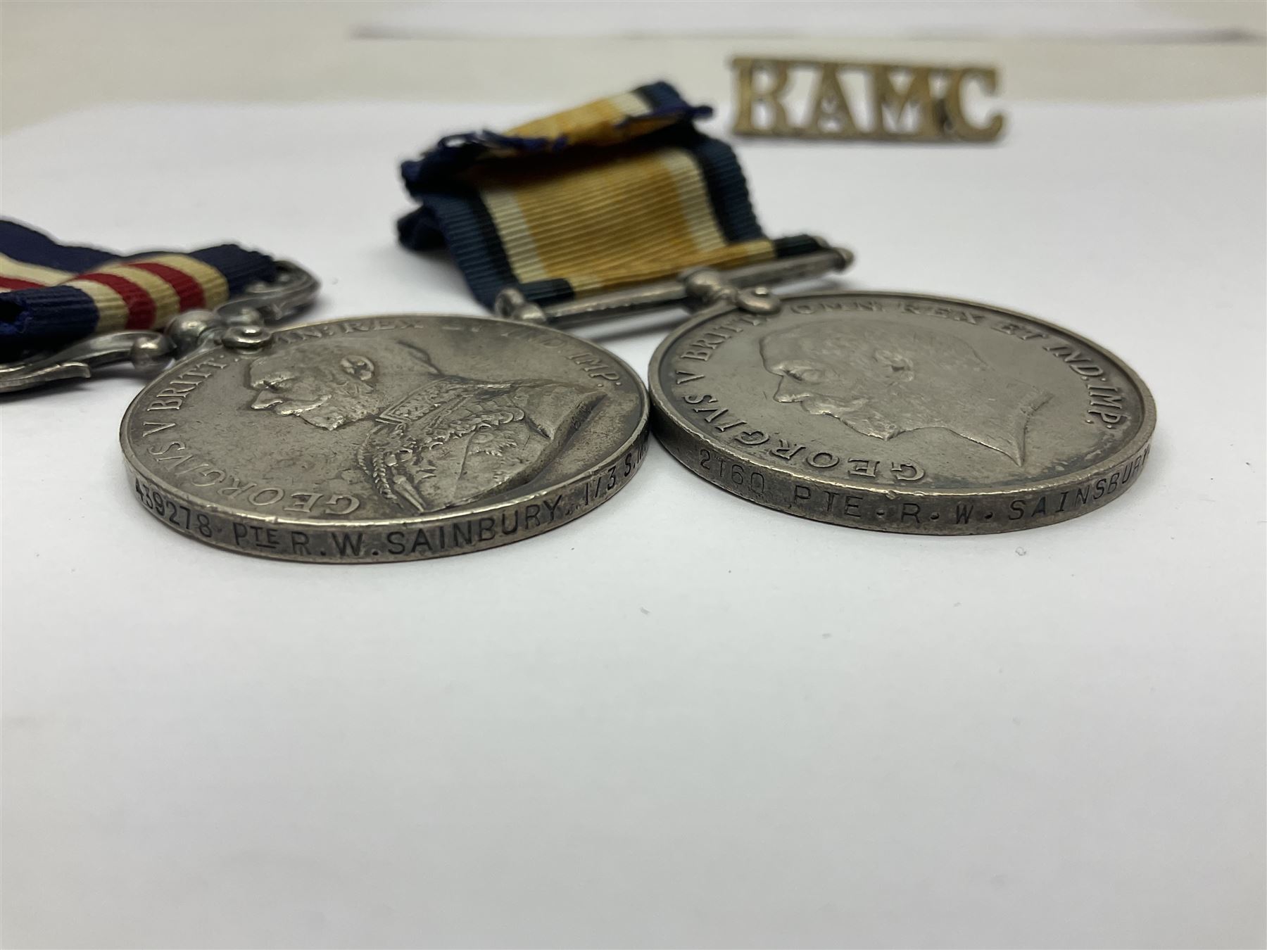 WWI RAMC Military Medal group of four comprising MM awarded to 439278 Pte. R.W. Sainsbury 1/3 S.M.F.A. R.A.M.C. T.F., British War Medal, Victory Medal and 1914-15 Star awarded to 2160 Pte. R.W. Sainsbury R.A.M.C.; all with ribbons; together with RAMC shoulder title
