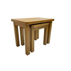 Light oak nest of two tables, rectangular top raised on square supports