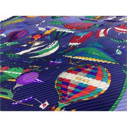 Hermès 'Les Folies Du Ciel' plisse silk scarf, designed by Loïc Dubigeon, printed with hot air balloon motifs, contained within twisted green rope border, on merging light and navy blue ground, with rolled hand stitched edges and Hermes material label, length 129cm