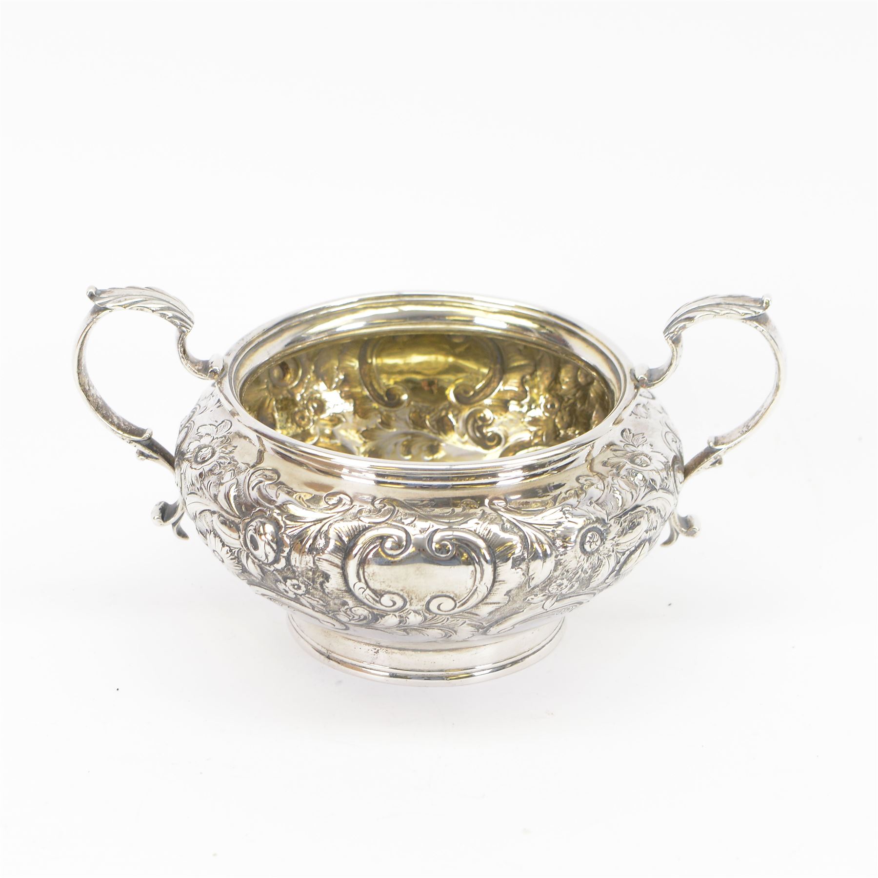 William IV silver twin handled sugar bowl, embossed with flowers and scrolling decoration with acanthus capped twin handles, hallmarked J Wrangham & William Moulson, London 1837, H10cm, D14cm