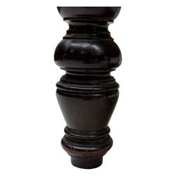 Late Victorian carved mahogany open armchair, the shaped back with fluted upholstered panel and padded arms above pierced scroll carved side supports, over a broad upholstered seat, on turned front supports